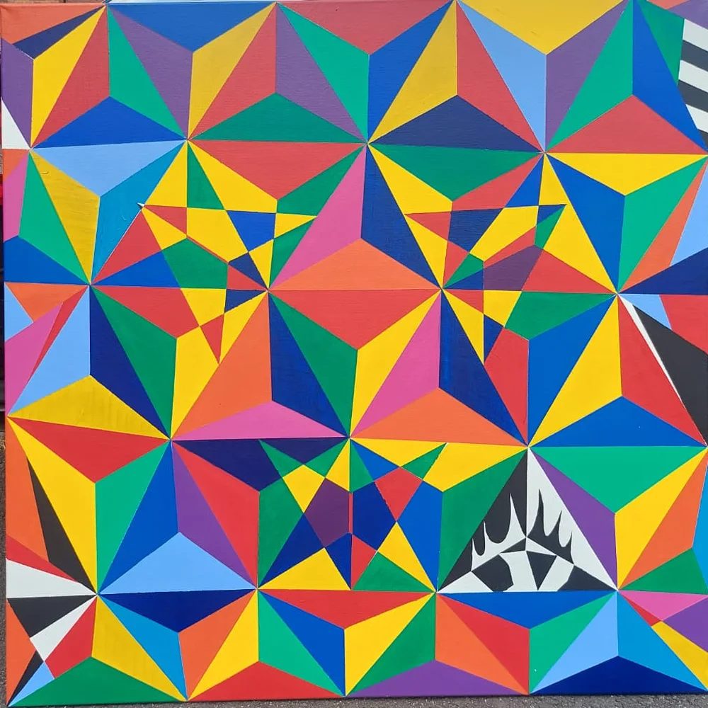 A square canvas covered edge to edge in ruled, flat-painted triangles — red, cobalt, yellow, green, magenta, purple and orange — repeating outward as a kaleidoscope, with a black-and-white third eye in the bottom right corner.